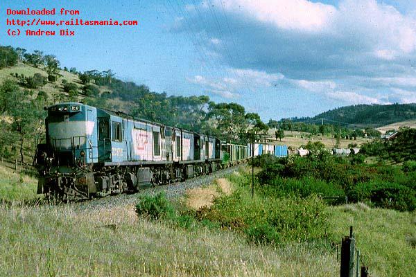 Still in the livery of the Queensland Railways, Tasrail ZC37 heads ZC41 and ZC31 and northbound train 3116 between Tea Tree and Rekuna, December 1989