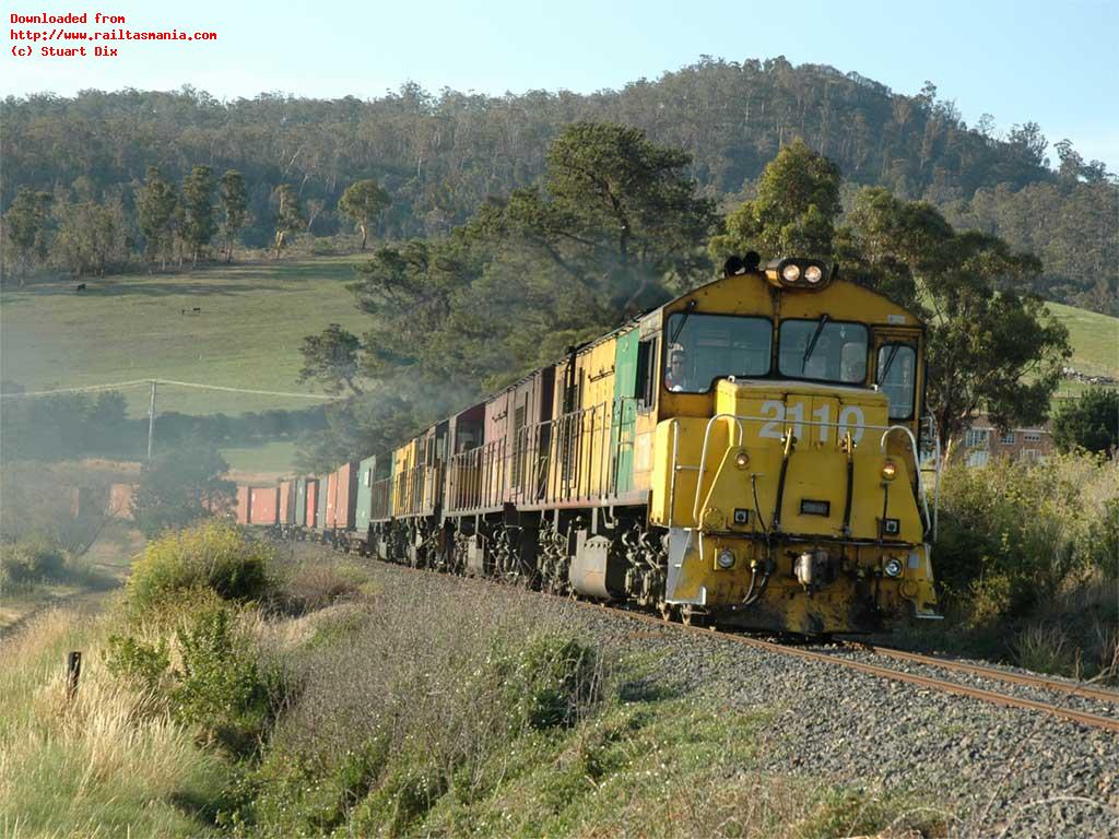 The late summer afternoon sun on 18 January 2007 illuminates paper train 532 as Z2110-Z2113-ZA2116-Z2111 head east at Ravenswood on the Derwent Valley Line. Being a Tuesday, the 35 wagon consist is a block load of 12.2m containers bound for Bell Bay