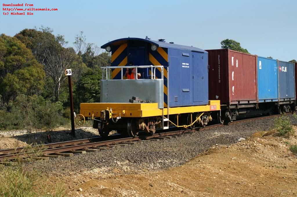 The rail operator keeps a good lookout and talks to his driver by radio as van ZX 1 leads train 53 from Bell Bay wharf to the marshalling yard at George Town, October 2007