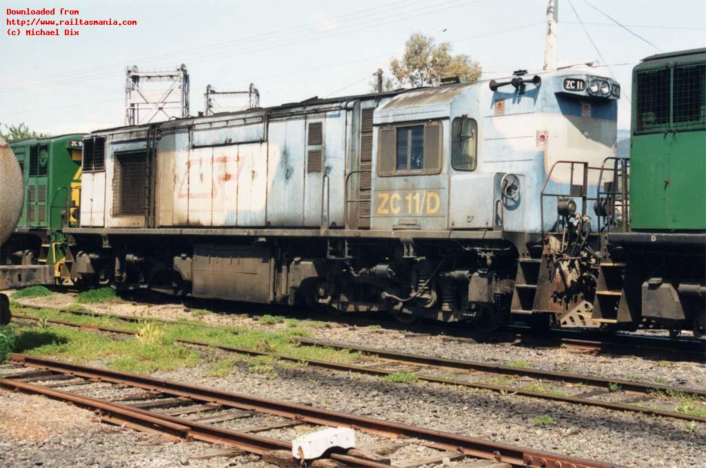 Sandwiched between two repainted class members, ZC11 works a train through at Bridgewater, October 1991