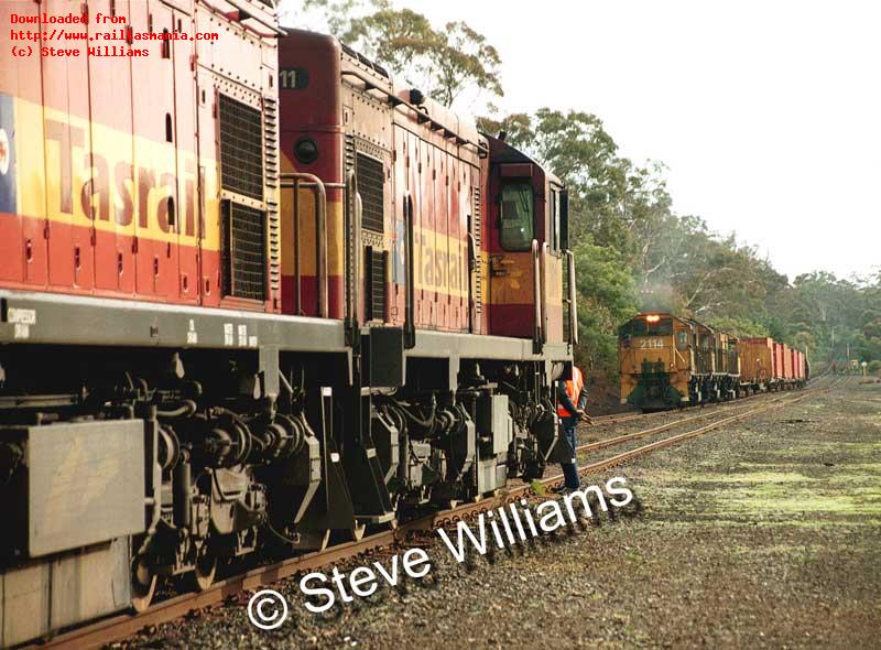 Loco 2011 on coal train 446, waits to cross train 443 with locos 2114-2118-2117 at Conara. July 2003