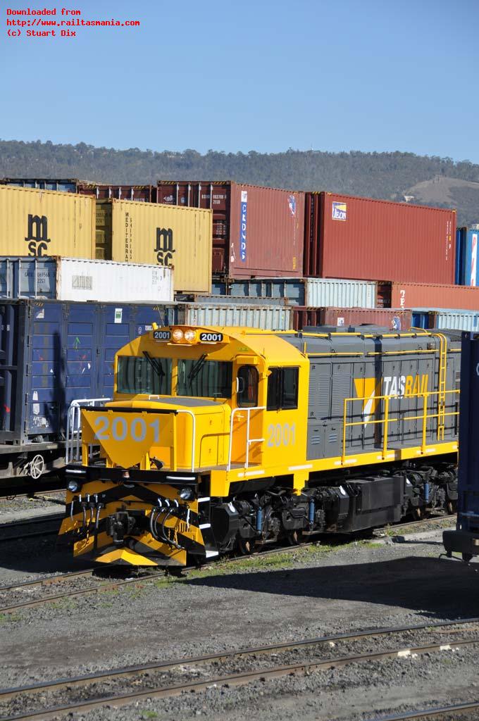 Newly released to service, loco 2001 displays the new TasRail corporate colour scheme as it sits in Hobart and surrounded by containers before heading to Boyer on a short train 664 on Friday 3 September 2010