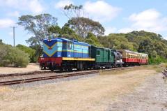 Former Emu Bay Railway locomotive 1002 leads a train of ex Tasmanian Government Railway vehicles int