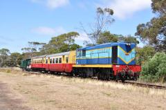Former Emu Bay Railway locomotive 1002 leads a train of ex Tasmanian Government Railway vehicles int