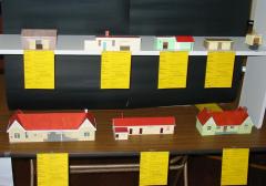Part of a building display by the Tasmanian Rail Modellers. <br />Top Row (L to R): Type E goods shed, Tonganah (Forester) station building, Lietinna station building, Gang shed (Colebrook), Standard Waiting Shelter<br />Second Row (L to R): 80' Type K station - Fingal, Hobart yrd building, 60' Type L station - Leith